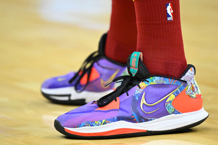 View of purple, black, and white Nike Kyrie shoes.